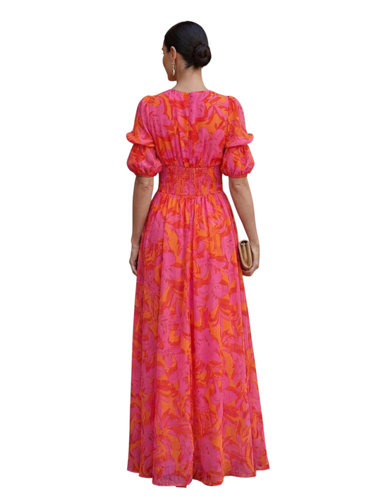 Vestido maxi Mara Domínguez de gasa con estampado floral rosa y naranja, mangas abullonadas y espalda vista